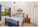 Bedroom featuring a bed, bedside tables with lamps, and a window with palm tree views at 356 Blackbird Ct, Bradenton, FL 34212