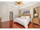 Bedroom with hardwood floors, a king-size bed, nightstands, and access to an en-suite bathroom at 356 Blackbird Ct, Bradenton, FL 34212
