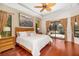Bedroom with hardwood floors, a king-size bed, nightstands, and sliding glass doors to outdoor living area at 356 Blackbird Ct, Bradenton, FL 34212