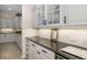 Elegant butlers pantry featuring modern cabinetry, stone backsplash, and a wine refrigerator for seamless service at 356 Blackbird Ct, Bradenton, FL 34212