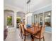 Bright dining room with an elegant chandelier, comfortable seating, and mirrors for added visual depth at 356 Blackbird Ct, Bradenton, FL 34212