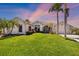 Beautiful single-story home with lush lawn and manicured tropical landscaping at 356 Blackbird Ct, Bradenton, FL 34212