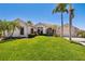 Beautiful single-story home with lush lawn and manicured tropical landscaping at 356 Blackbird Ct, Bradenton, FL 34212