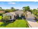 Beautiful single-story home with lush lawn and manicured tropical landscaping at 356 Blackbird Ct, Bradenton, FL 34212