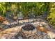 Outdoor space showcasing a stone fire pit surrounded by four chairs and flagstone patio at 356 Blackbird Ct, Bradenton, FL 34212