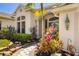 Charming front entrance with tropical landscaping, stone walkway and blue door at 356 Blackbird Ct, Bradenton, FL 34212