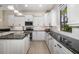Well-equipped kitchen with an island, granite countertops, white cabinets, and stainless steel appliances at 356 Blackbird Ct, Bradenton, FL 34212