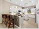 Well-equipped kitchen featuring white cabinetry, granite countertops, and bar seating at 356 Blackbird Ct, Bradenton, FL 34212