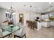 Open concept kitchen with white cabinetry, stone accent wall and a kitchen island with bar stool seating at 356 Blackbird Ct, Bradenton, FL 34212