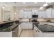 Modern kitchen with granite countertops, white cabinets, and stainless steel appliances for a sleek design at 356 Blackbird Ct, Bradenton, FL 34212