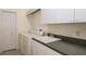 Laundry room equipped with washer, dryer, utility sink, and built-in cabinets at 356 Blackbird Ct, Bradenton, FL 34212