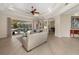 Spacious living room with hardwood floors, high ceilings, and view of outdoor pool at 356 Blackbird Ct, Bradenton, FL 34212