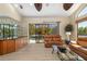 Open living room with a bar area and sliding glass doors to the screened lanai and pool at 356 Blackbird Ct, Bradenton, FL 34212