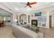 Bright living room features a fireplace, tray ceilings, and modern furniture for comfortable living at 356 Blackbird Ct, Bradenton, FL 34212