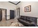 Office space with wood floors, black futon, and access to an adjacent bathroom and hallway at 356 Blackbird Ct, Bradenton, FL 34212