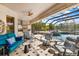 A spacious patio with seating around the pool and outdoor kitchen enhances outdoor living at 356 Blackbird Ct, Bradenton, FL 34212
