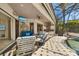 Relaxing outdoor seating area with views of the pool, lake, and outdoor kitchen at 356 Blackbird Ct, Bradenton, FL 34212