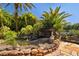Charming backyard pond with a stone waterfall and natural landscaping adds a tranquil touch at 356 Blackbird Ct, Bradenton, FL 34212