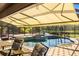 Relax near the pool with the retractable awning, screened lanai, and tropical landscaping at 356 Blackbird Ct, Bradenton, FL 34212