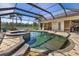 Inviting screened-in pool and spa area with lake views, perfect for relaxation and entertainment at 356 Blackbird Ct, Bradenton, FL 34212