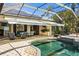 Beautiful screened-in lanai with a pool, seating, and an outdoor kitchen at 356 Blackbird Ct, Bradenton, FL 34212