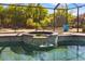Screened pool with integrated spa and lush landscaping provides a tropical backyard retreat at 356 Blackbird Ct, Bradenton, FL 34212