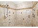 Luxurious tiled shower features a built-in bench, multiple shower heads, and decorative accents at 356 Blackbird Ct, Bradenton, FL 34212