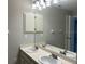 Bright bathroom with dual sinks, vanity, and a large mirror at 3602 Bonaventure Ct, Sarasota, FL 34243