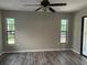 Spacious bedroom with multiple windows, neutral paint, ceiling fan and wood flooring at 3602 Bonaventure Ct, Sarasota, FL 34243