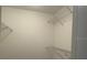 This walk-in closet features metal racks for storage and organization at 3602 Bonaventure Ct, Sarasota, FL 34243