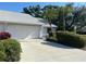 A single Gathering home showcasing the driveway leading to the attached garage at 3602 Bonaventure Ct, Sarasota, FL 34243