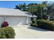 A single Gathering home showcasing the driveway leading to the attached garage at 3602 Bonaventure Ct, Sarasota, FL 34243