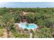 Aerial view showcasing a community pool and lush landscaping at 3803 Sun Eagle Ln # 203, Bradenton, FL 34210