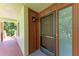 Close up of unit entrance with decorative trim, door, and an outdoor light fixture at 3803 Sun Eagle Ln # 203, Bradenton, FL 34210