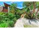 Inviting walkway leading to the entrance with lush tropical landscaping at 3803 Sun Eagle Ln # 203, Bradenton, FL 34210