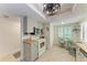 Bright kitchen with white appliances, stylish wicker chairs, and plenty of counter space for meal preparation at 3803 Sun Eagle Ln # 203, Bradenton, FL 34210