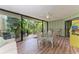 Inviting lanai with a glass table and lush outdoor views and arcade game at 3803 Sun Eagle Ln # 203, Bradenton, FL 34210