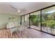 Comfortable lanai with glass table, outdoor seating, and lush tropical views at 3803 Sun Eagle Ln # 203, Bradenton, FL 34210