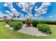 Lush green lawn accented with pink flowering shrubs and tropical greenery creates a tranquil outdoor space at 3803 Sun Eagle Ln # 203, Bradenton, FL 34210