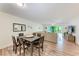 Open-concept living and dining area with comfortable seating and access to the balcony at 3803 Sun Eagle Ln # 203, Bradenton, FL 34210