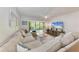 Spacious living room with a comfortable couch and a beautiful view from the lanai at 3803 Sun Eagle Ln # 203, Bradenton, FL 34210