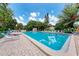 Community pool with lounge chairs and lush landscaping surrounding it at 3803 Sun Eagle Ln # 203, Bradenton, FL 34210