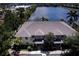 Aerial shot of condo complex near a lake with well-maintained roofs, and lovely grounds and lakeside views at 3909 45Th W Ter # 102, Bradenton, FL 34210