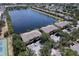 Stunning aerial view of condo community with lake, surrounded by lush greenery, offering serene lakeside living at 3909 45Th W Ter # 102, Bradenton, FL 34210
