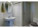 Cozy bathroom featuring a pedestal sink, mirrored vanity, and a conveniently placed toilet at 3909 45Th W Ter # 102, Bradenton, FL 34210