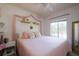 Comfortable bedroom with soft pink accents, closet and natural light from window at 3909 45Th W Ter # 102, Bradenton, FL 34210