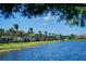 Scenic view of a tranquil lakefront condo community, showcasing lush green spaces and serene waterfront living at 3909 45Th W Ter # 102, Bradenton, FL 34210
