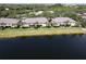 Waterfront condos feature a well-maintained lawn, mature palms, and tranquil lake views at 3909 45Th W Ter # 102, Bradenton, FL 34210
