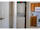 Efficient laundry closet with a stacked washer and dryer unit, located adjacent to the kitchen area at 3909 45Th W Ter # 102, Bradenton, FL 34210