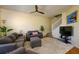 Comfortable living room features plush furniture, ceiling fan, and staircase access at 3909 45Th W Ter # 102, Bradenton, FL 34210